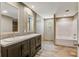 Bathroom with double vanity, tub and shower highlighted by wood-look floors at 317 Marion Rd, Dorchester, SC 29437