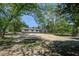 Single-story home has a driveway and a large yard with trees adding privacy and charm at 317 Marion Rd, Dorchester, SC 29437