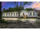Single-story home with gray siding, black shutters, and a well-manicured front yard at dusk at 317 Marion Rd, Dorchester, SC 29437