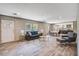 Bright and airy living room features a modern couch, wood-look flooring, and neutral walls at 317 Marion Rd, Dorchester, SC 29437