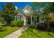 Charming single-Gathering home with a well-manicured lawn, inviting front porch, and beautiful landscaping at 320 Foxglove Ave, Summerville, SC 29483