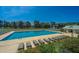 An inviting swimming pool area with clear blue water, lounge chairs, and lush landscaping, perfect for summer relaxation at 320 Foxglove Ave, Summerville, SC 29483