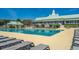 A spacious pool area with clear water, lounge chairs, and a clubhouse, perfect for community enjoyment and relaxation at 320 Foxglove Ave, Summerville, SC 29483
