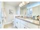 Bright bathroom features a double sink vanity, gray countertops, large mirror and shower with glass door at 3208 Pecan Orchard Way, Charleston, SC 29414