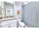 Nicely appointed bathroom with a single sink vanity, striped shower curtain and toilet at 3208 Pecan Orchard Way, Charleston, SC 29414