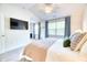 This cozy bedroom features a plush bed, mounted TV and a well-lit atmosphere at 3208 Pecan Orchard Way, Charleston, SC 29414