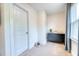 A bright room with a storage unit, door and window provides a functional and inviting atmosphere at 3208 Pecan Orchard Way, Charleston, SC 29414