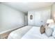 The bright bedroom has white walls, a neutral rug, and white bedding creating a peaceful atmosphere at 3208 Pecan Orchard Way, Charleston, SC 29414
