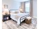 This cozy bedroom features a metal frame bed with a plush rug, and a bedside table with a lamp at 3208 Pecan Orchard Way, Charleston, SC 29414