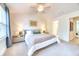 This cozy bedroom has a plush bed and a doorway to the ensuite bathroom offering convenience and comfort at 3208 Pecan Orchard Way, Charleston, SC 29414