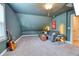 Cozy bonus room features plush carpeting, a comfortable gray sofa, and a vintage-style travel poster accenting the wall at 3208 Pecan Orchard Way, Charleston, SC 29414