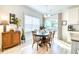 Inviting dining area with natural light, a round table with seating for six, and stylish decor at 3208 Pecan Orchard Way, Charleston, SC 29414