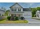 Inviting two-story home with a classic design, lush landscaping, and a welcoming front porch in a suburban setting at 3208 Pecan Orchard Way, Charleston, SC 29414