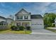 Charming two-story home with a well-maintained front yard and an attached two-car garage in a nice neighborhood at 3208 Pecan Orchard Way, Charleston, SC 29414