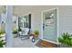 Welcoming front porch with stylish seating, potted plants, and a charming 'Welcome to our Home' door sign at 3208 Pecan Orchard Way, Charleston, SC 29414