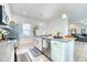 Bright kitchen featuring stainless steel appliances, white cabinets, and a large island with a bar sink at 3208 Pecan Orchard Way, Charleston, SC 29414