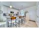 Bright kitchen featuring white cabinets, stainless appliances, large island with bar seating, and modern fixtures at 3208 Pecan Orchard Way, Charleston, SC 29414
