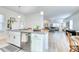 Bright kitchen showcases an island with bar seating, stainless steel appliances, and an open layout to living area at 3208 Pecan Orchard Way, Charleston, SC 29414