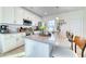 A well-lit kitchen with white cabinets, stainless steel appliances, and a spacious island at 3208 Pecan Orchard Way, Charleston, SC 29414