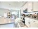 Open-concept kitchen with a large island, stainless steel appliances, and plenty of natural light at 3208 Pecan Orchard Way, Charleston, SC 29414
