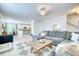 Open-concept living room with a sectional, dining area, and kitchen, perfect for modern living and entertaining at 3208 Pecan Orchard Way, Charleston, SC 29414