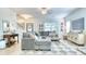 Bright living room showcasing a cozy gray sectional, contemporary decor, and an open layout leading to other spaces at 3208 Pecan Orchard Way, Charleston, SC 29414