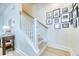 Elegant staircase features white railings, hardwood steps, and tasteful wall decor, adding charm to the home's interior at 3208 Pecan Orchard Way, Charleston, SC 29414