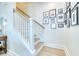 Bright staircase features white railings, hardwood steps, and stylish wall decor creating a welcoming atmosphere at 3208 Pecan Orchard Way, Charleston, SC 29414