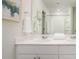 Bright bathroom features double sinks, a large mirror, and a shower with white curtains at 325 Tiliwa St, Summerville, SC 29486