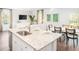 Stylish kitchen island with granite countertops, stainless steel sink, and seating, flowing into the dining area at 325 Tiliwa St, Summerville, SC 29486