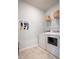 Practical laundry room featuring modern washer and dryer units, shelving, and storage at 325 Tiliwa St, Summerville, SC 29486