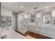 Bright bathroom with double sinks, marble shower, soaking tub, and modern fixtures at 330 Concord St # 18F, Charleston, SC 29401