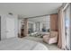 Spacious bedroom features light walls, mirrored wall, glass stair rail, and comfortable sitting area at 330 Concord St # 18F, Charleston, SC 29401