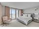Airy bedroom with balcony access features light colored walls, neutral carpet, and comfortable sitting area at 330 Concord St # 18F, Charleston, SC 29401