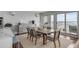 Dining room features a wooden table with upholstered chairs and view of balcony and skyline at 330 Concord St # 18F, Charleston, SC 29401