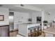 Modern white kitchen with stainless steel appliances and an island with bar stool seating at 330 Concord St # 18F, Charleston, SC 29401