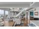Bright and open living room with a soaring ceiling, modern staircase, and luxury decor at 330 Concord St # 18F, Charleston, SC 29401