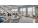 Stylish living area with a comfortable sofa, balcony access, and beautiful water views at 330 Concord St # 18F, Charleston, SC 29401