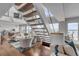 Open-concept living room featuring a modern staircase and water views from the terrace at 330 Concord St # 18F, Charleston, SC 29401