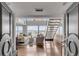 Bright, open-concept living room with hardwood floors, staircase, and water views at 330 Concord St # 18F, Charleston, SC 29401
