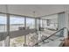 Bright living room showcasing water views and modern glass railings leading to a serene bedroom space at 330 Concord St # 18F, Charleston, SC 29401