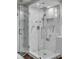 Modern glass shower with marble tile, rain shower head, and built-in shelving at 330 Concord St # 18F, Charleston, SC 29401