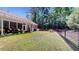 Lush fenced backyard with screened in patio and verdant green space at 3997 Aspera Dr, Summerville, SC 29483