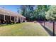 Lush fenced backyard with screened in patio and verdant green space at 3997 Aspera Dr, Summerville, SC 29483