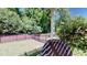 Well-maintained backyard features a black metal fence, lush lawn, and mature trees at 3997 Aspera Dr, Summerville, SC 29483