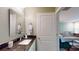 Granite countertop with a decorative mirror is featured in this well-lit bathroom at 3997 Aspera Dr, Summerville, SC 29483