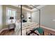 Elegant bedroom with a four-poster bed, hardwood flooring, and matching nightstands at 3997 Aspera Dr, Summerville, SC 29483
