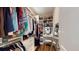 Walk-in closet featuring custom shelving for clothes, shoes and accessories with hardwood flooring at 3997 Aspera Dr, Summerville, SC 29483