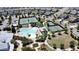 Aerial view of the neighborhood tennis courts and community pool surrounded by many homes at 3997 Aspera Dr, Summerville, SC 29483