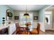 Charming dining area featuring a glass table and wicker chairs, complemented by a stylish light fixture at 3997 Aspera Dr, Summerville, SC 29483